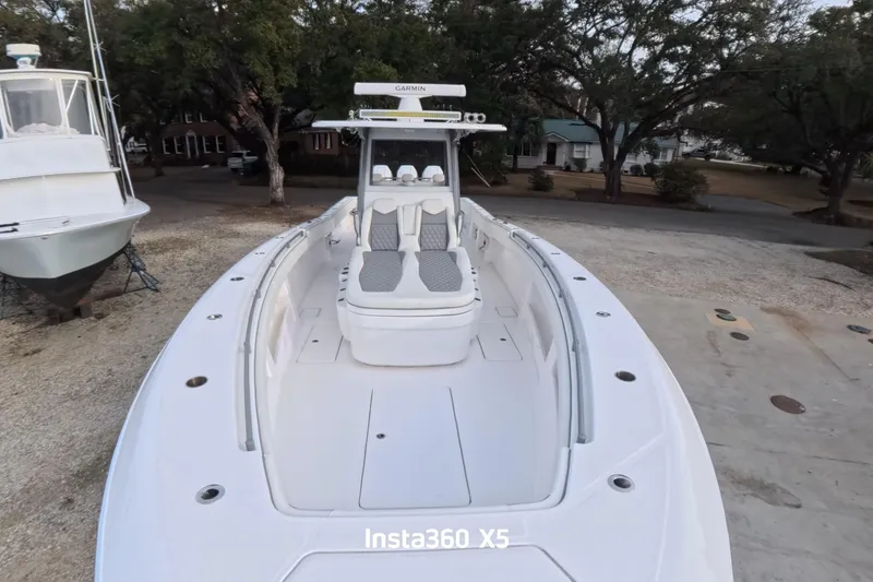 Slide: The Image of 2025 Invincible 39 Open Fisherman boat with sleek design, docked outdoors. - 9