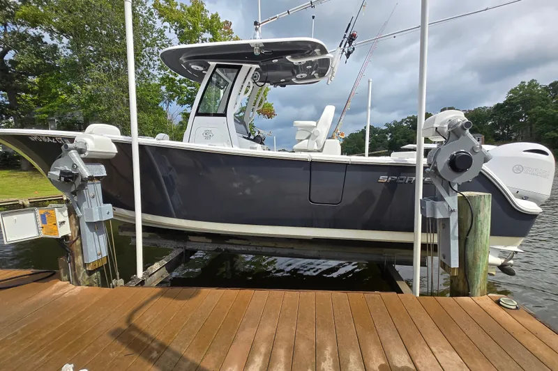 The Image of 2022 Sportsman Open 262 Center Console boat on lift, dockside view. - 0