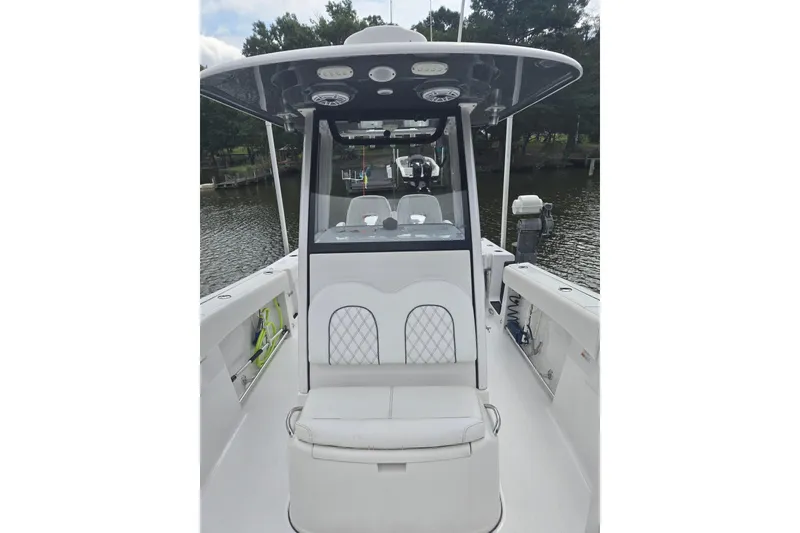 Slide: The Image of 2022 Sportsman Open 262 Center Console boat on calm water, featuring sleek design and modern amenities. - 5