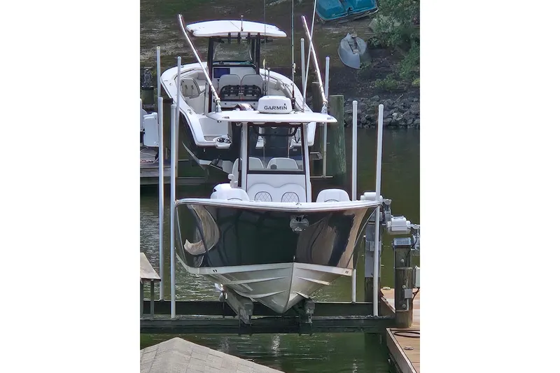 Slide: The Image of 2022 Sportsman Open 262 Center Console boat docked on a lift. - 7