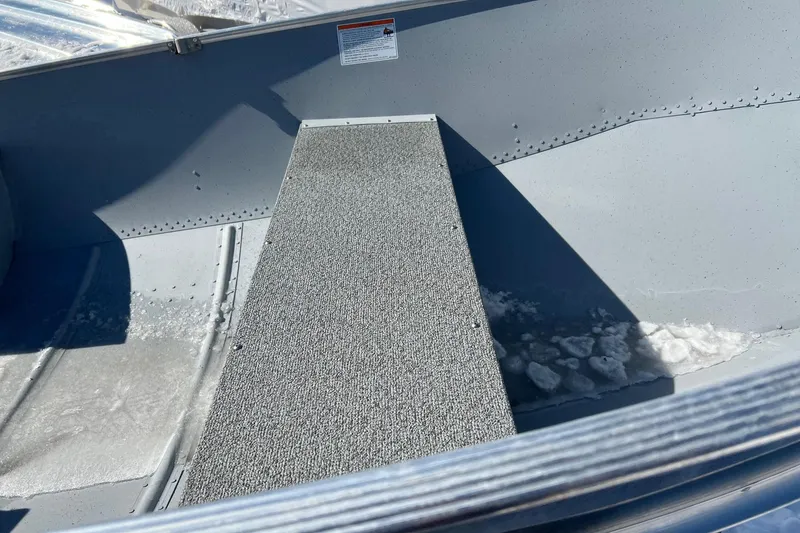 Slide: The Image of Interior of 2026 Lund WC-12 boat with textured flooring and metal finish. - 3