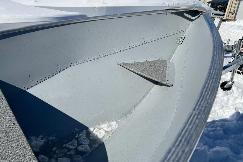 Slide: The Image of 2026 Lund WC-12 boat interior with textured flooring and metal rivets. - 4