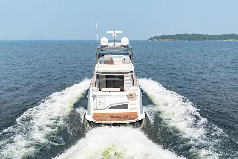Slide: The Image of 2023 Azimut Fly 53 yacht cruising on open water, rear view. - 18
