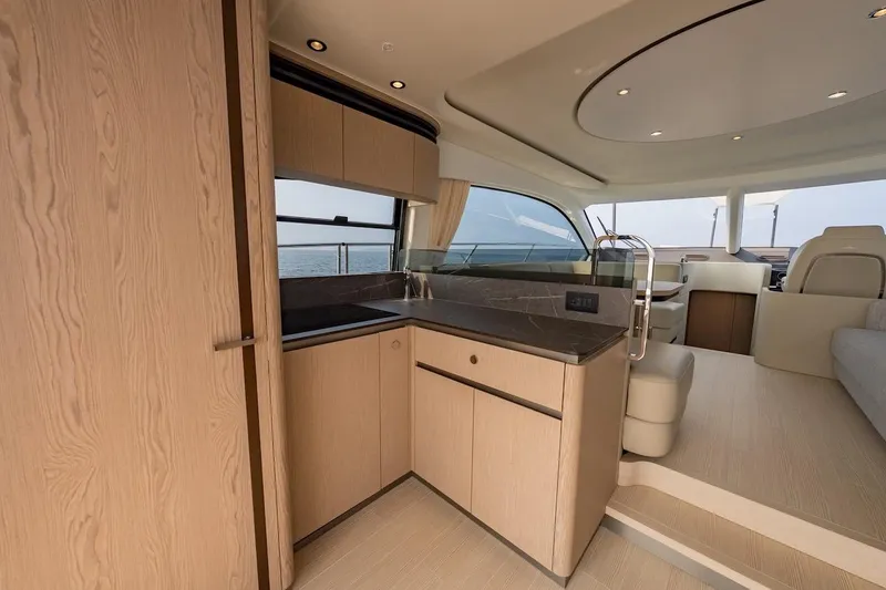 Slide: The Image of Luxurious interior of 2023 Azimut Fly 53 yacht, featuring modern kitchen and seating area. - 25