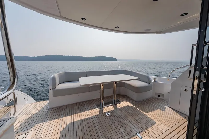 Slide: The Image of Luxury Azimut Fly 53 yacht deck with seating, overlooking serene water and distant shoreline. - 40
