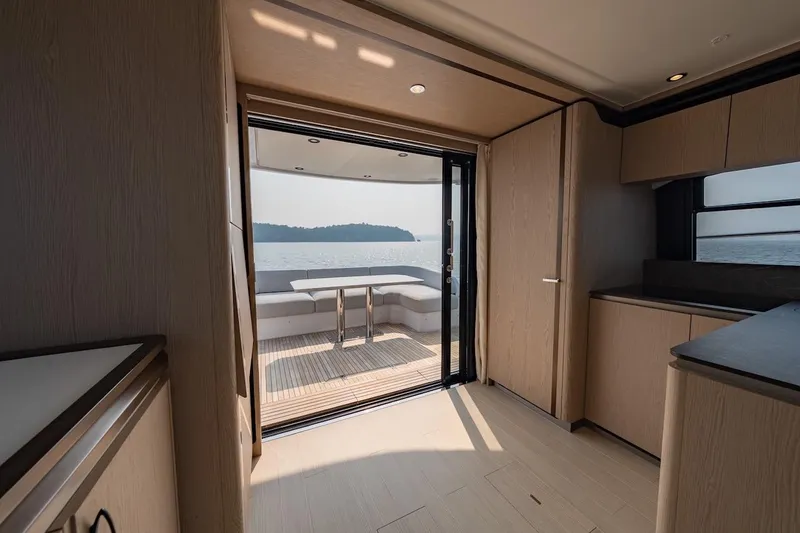 Slide: The Image of Interior view of 2023 Azimut Fly 53 yacht, featuring elegant wood finishes and ocean view. - 43