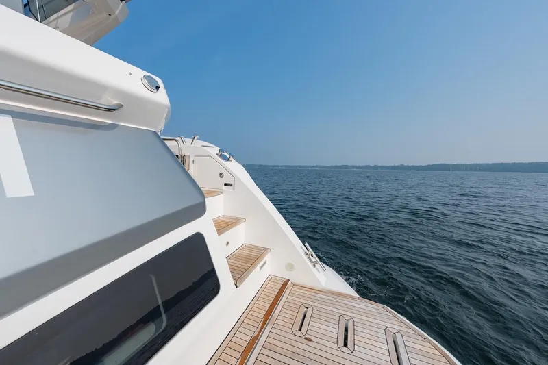Slide: The Image of 2023 Azimut Fly 53 yacht deck with ocean view under clear blue sky. - 46