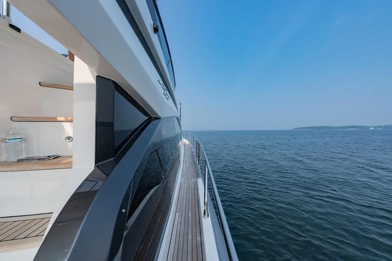 Slide: The Image of 2023 Azimut Fly 53 yacht cruising on open water under clear blue sky. - 49