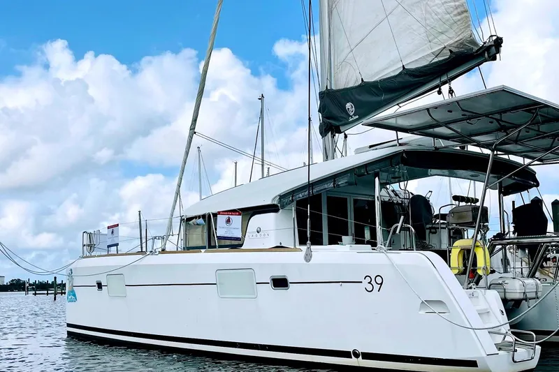 The Image of 2017 Lagoon 39 catamaran sailing on calm waters under a partly cloudy sky. - 0