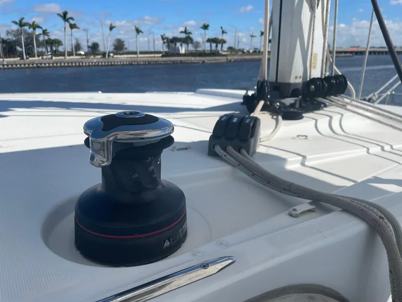 Slide: The Image of Lagoon 39 sailboat deck with winch, ropes, and palm trees in the background, 2017 model. - 14
