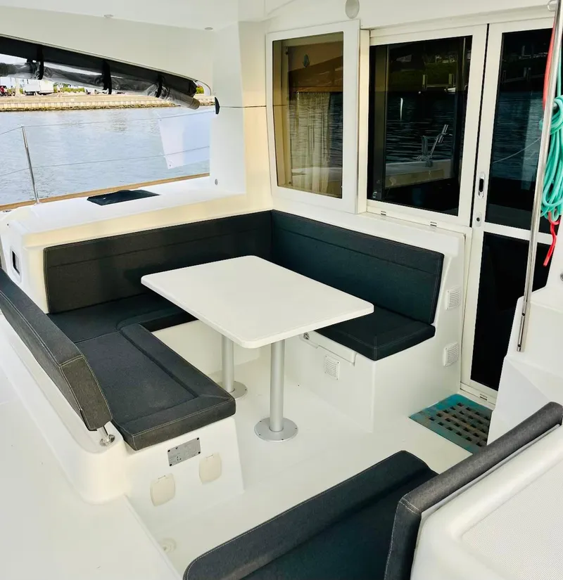 Slide: The Image of 2017 Lagoon 39 yacht interior with sleek seating and table by the water. - 16