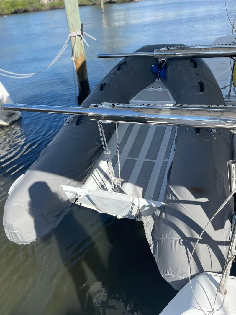 Slide: The Image of 2017 Lagoon 39 inflatable boat docked on calm water. - 17