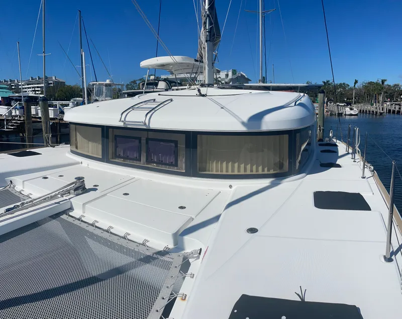 Slide: The Image of 2017 Lagoon 39 catamaran docked, showcasing spacious deck and sleek design. - 2