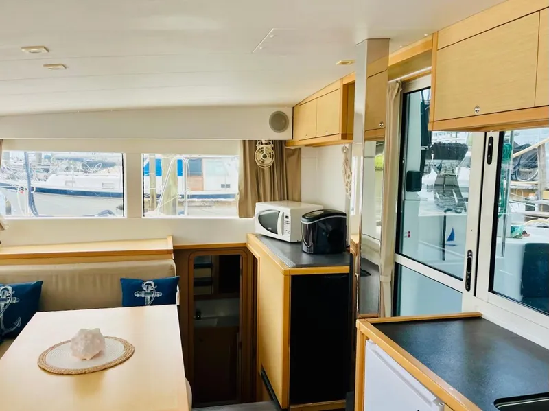Slide: The Image of Interior of 2017 Lagoon 39 catamaran with modern kitchen and dining area. - 28