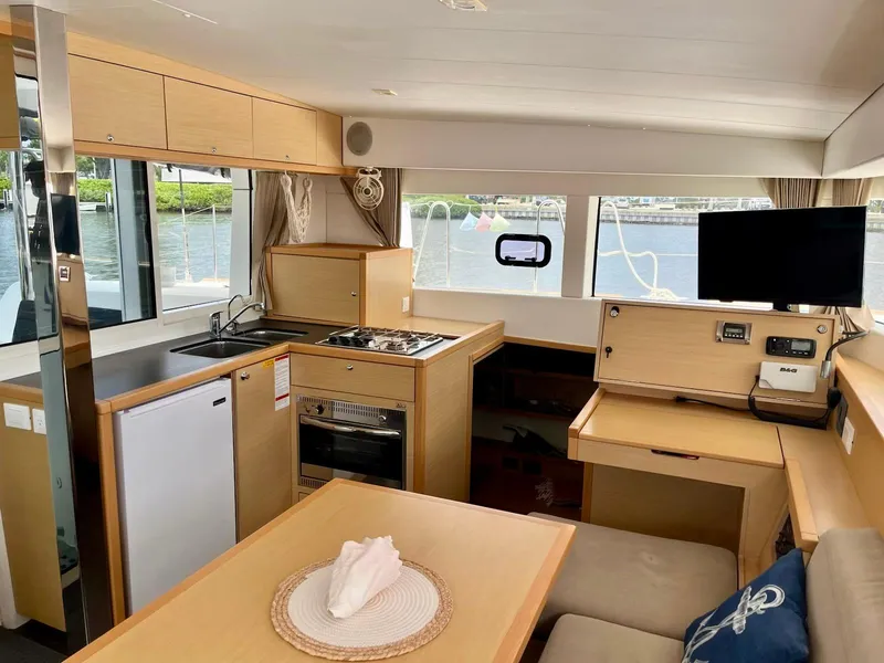 Slide: The Image of Interior of 2017 Lagoon 39 catamaran with modern kitchen, dining area, and waterfront view. - 30