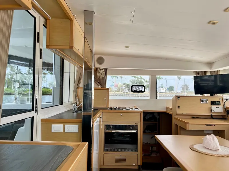 Slide: The Image of Interior of 2017 Lagoon 39 catamaran, featuring modern kitchen and dining area. - 31