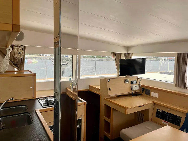 Slide: The Image of Interior of 2017 Lagoon 39 catamaran with modern kitchen and navigation station. - 32