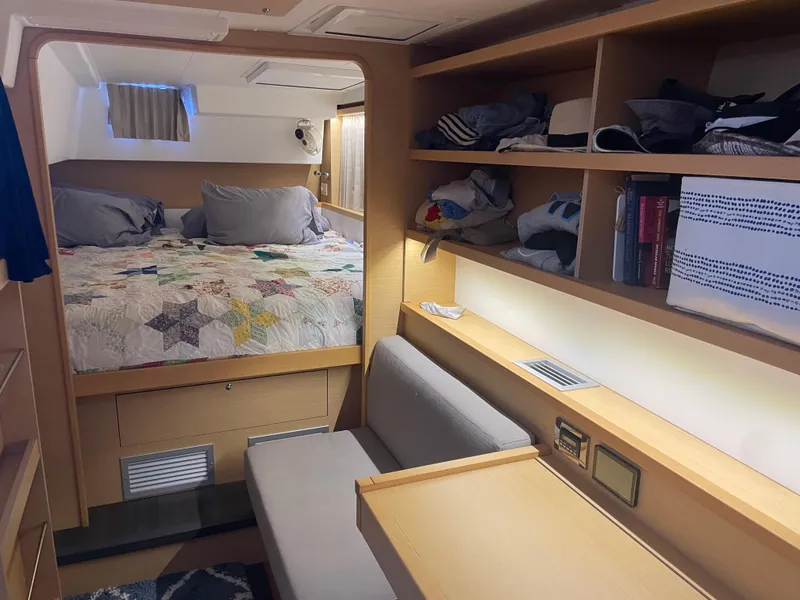 Slide: The Image of Interior of 2017 Lagoon 39 yacht cabin with bed, shelves, and seating area. - 37