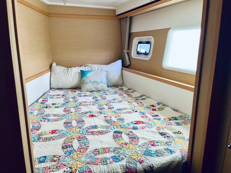 Slide: The Image of Cozy cabin bedroom in 2017 Lagoon 39 catamaran with colorful quilt and window view. - 43