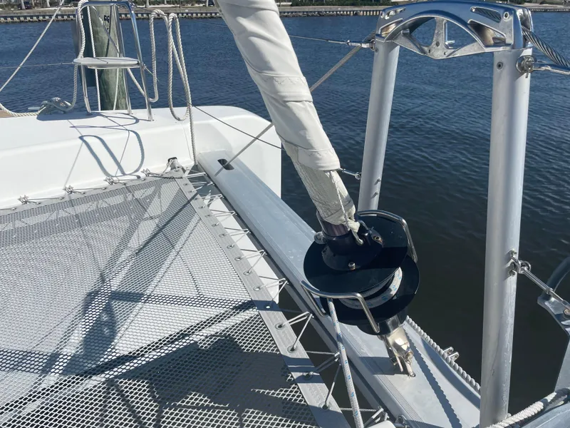 Slide: The Image of 2017 Lagoon 39 catamaran deck with rigging and netting over water. - 9
