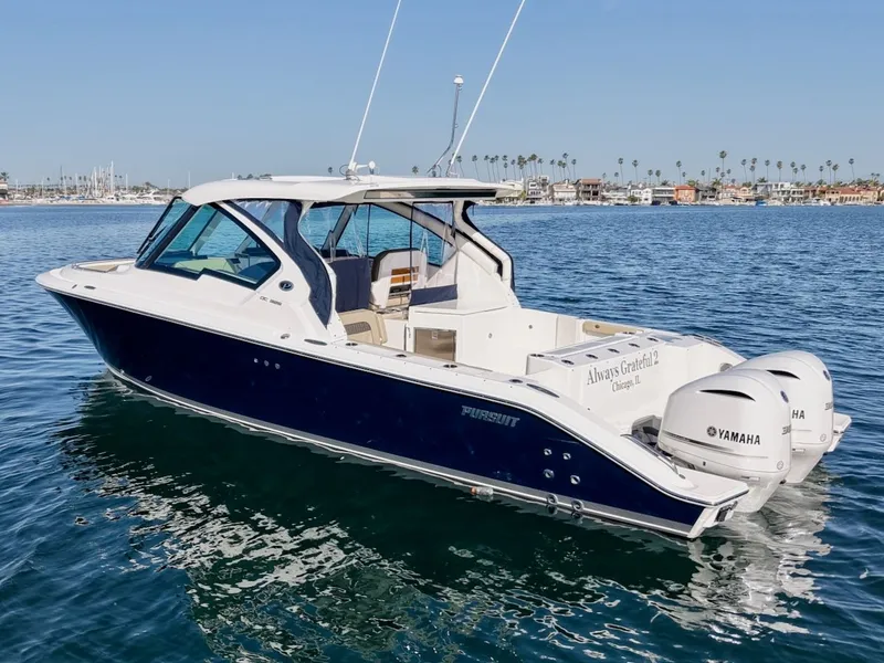 Slide: The Image of 2021 Pursuit DC 326 Dual Console boat on the water. - 5