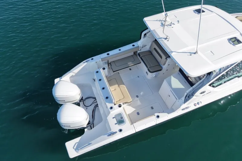 Slide: The Image of Aerial view of 2021 Pursuit DC 326 Dual Console on water. - 8