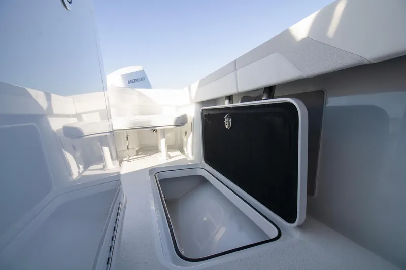 Slide: The Image of 2025 Yellowfin 32 Offshore boat interior with storage compartments and Mercury engine. - 14
