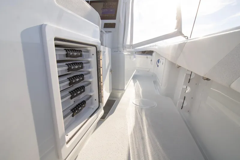 Slide: The Image of 2025 Yellowfin 32 Offshore boat interior with storage compartments and sleek design. - 18