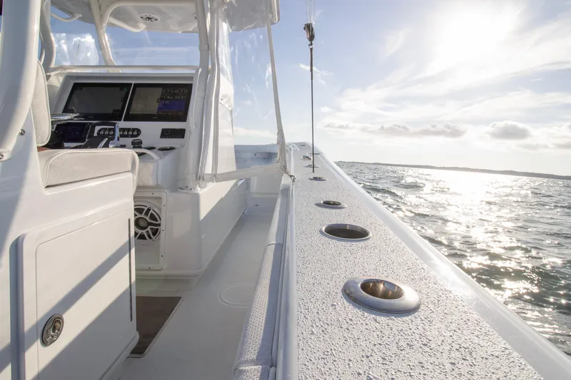 Slide: The Image of 2025 Yellowfin 32 Offshore boat interior with ocean view and sunlight. - 19
