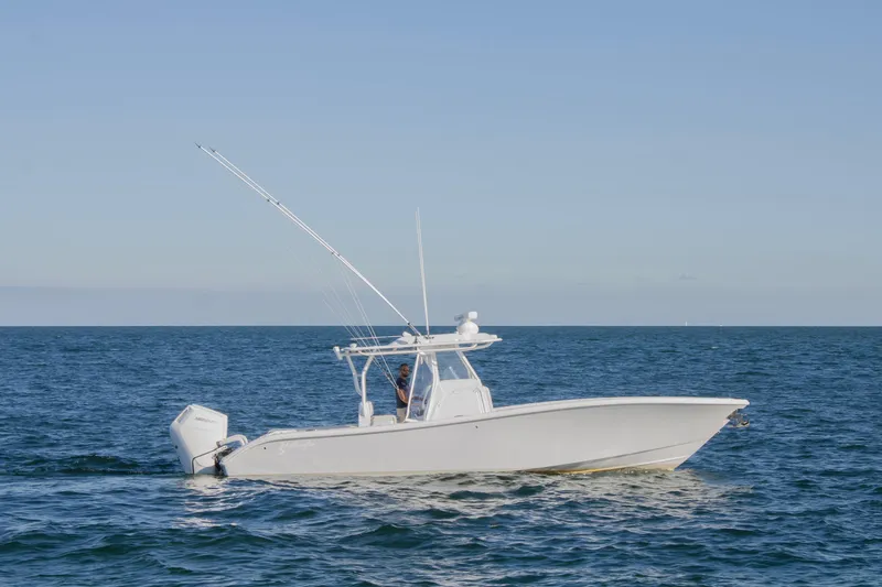 Slide: The Image of 2025 Yellowfin 32 Offshore boat cruising on open sea under clear blue sky. - 2