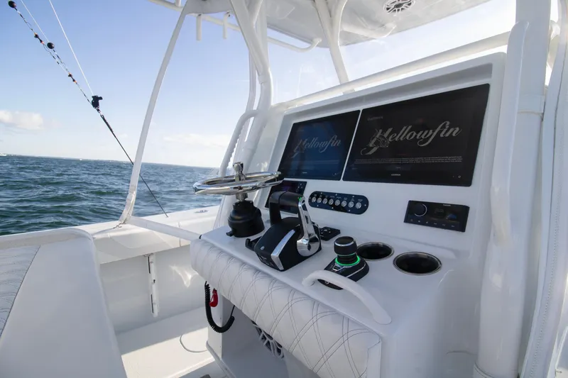 Slide: The Image of 2025 Yellowfin 32 Offshore boat console with steering wheel and navigation screens. - 21