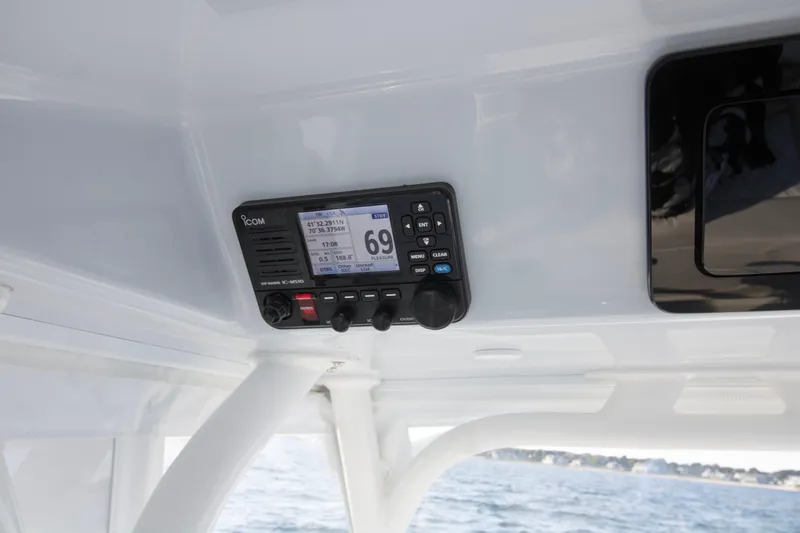 Slide: The Image of ICOM marine radio on 2025 Yellowfin 32 Offshore boat, displaying coordinates and channel. - 23