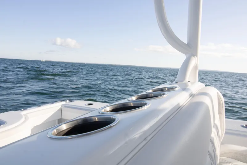 Slide: The Image of 2025 Yellowfin 32 Offshore boat on open sea, featuring sleek design and cup holders. - 24