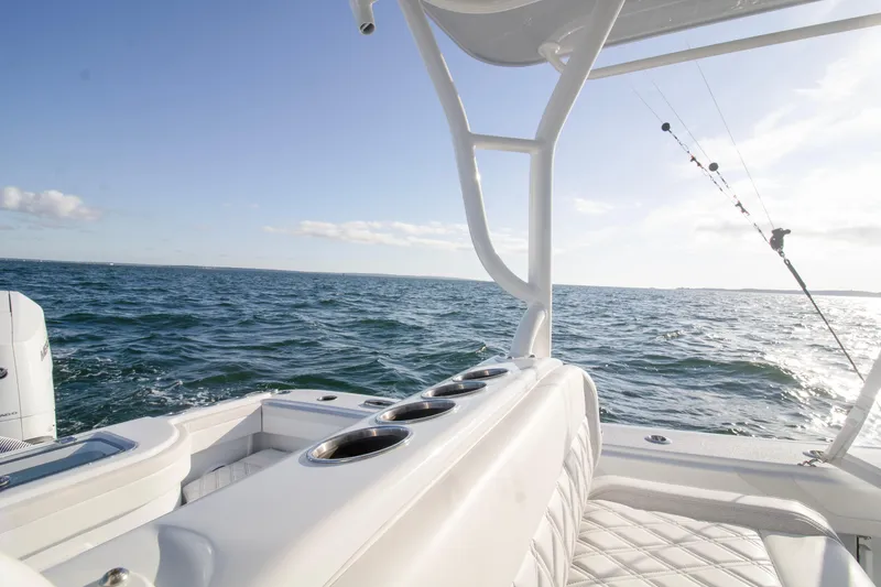 Slide: The Image of 2025 Yellowfin 32 Offshore boat on open sea with fishing rod. - 25