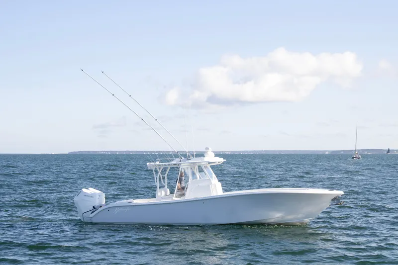 Slide: The Image of 2025 Yellowfin 32 Offshore boat cruising on open water under clear skies. - 3