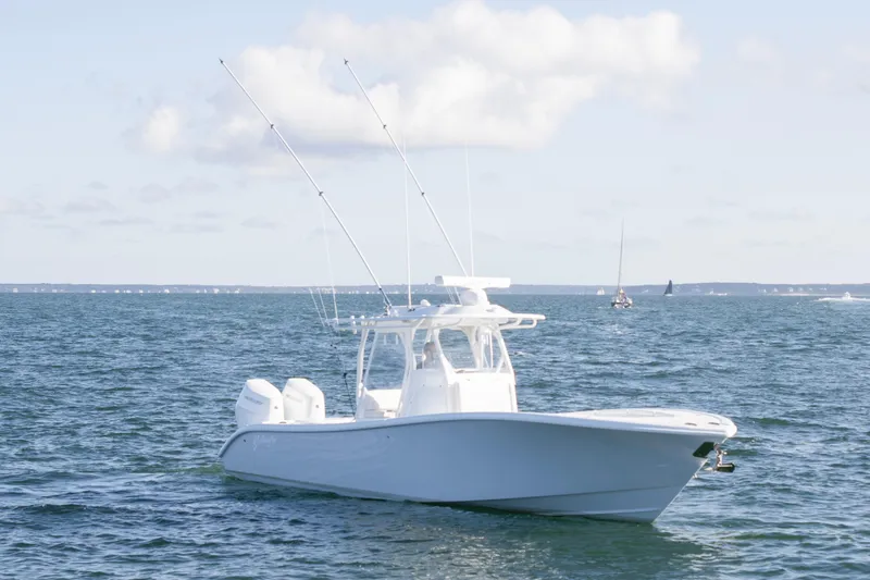 Slide: The Image of 2025 Yellowfin 32 Offshore boat on open water under a clear sky. - 4