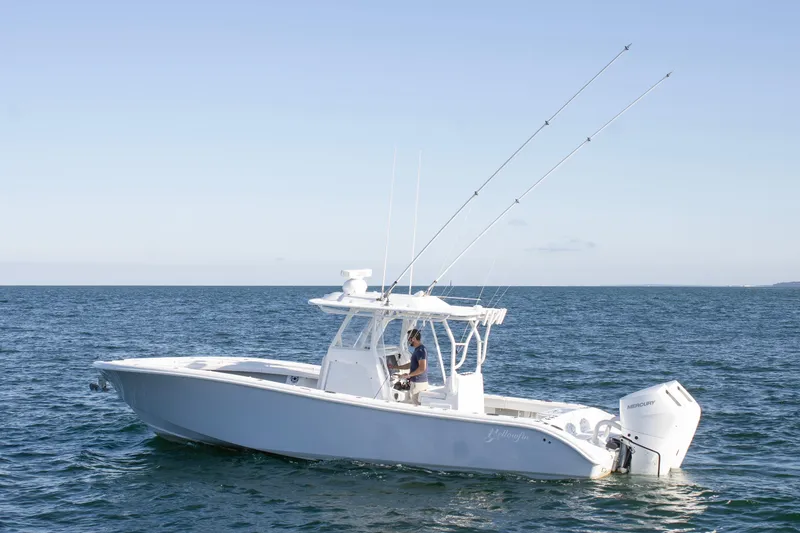 Slide: The Image of 2025 Yellowfin 32 Offshore boat on open water, featuring dual outboard engines. - 6