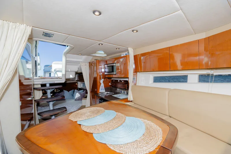 Slide: The Image of Interior of 2013 Sea Ray 370 Venture yacht with dining area and modern amenities. - 26