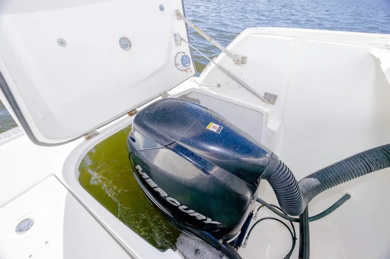 Slide: The Image of 2013 Sea Ray 370 Venture boat engine compartment with Mercury outboard motor. - 36