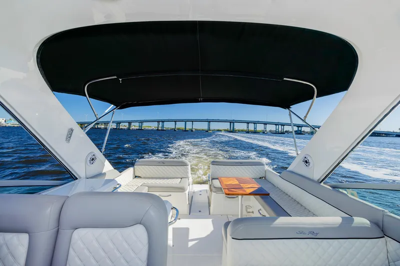 Slide: The Image of 2013 Sea Ray 370 Venture cruising on open water under a clear blue sky. - 9