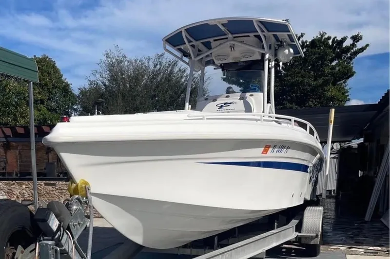 Slide: The Image of 2010 Glasstream 280 SCX boat on trailer, white hull, blue stripe, outdoor setting. - 2