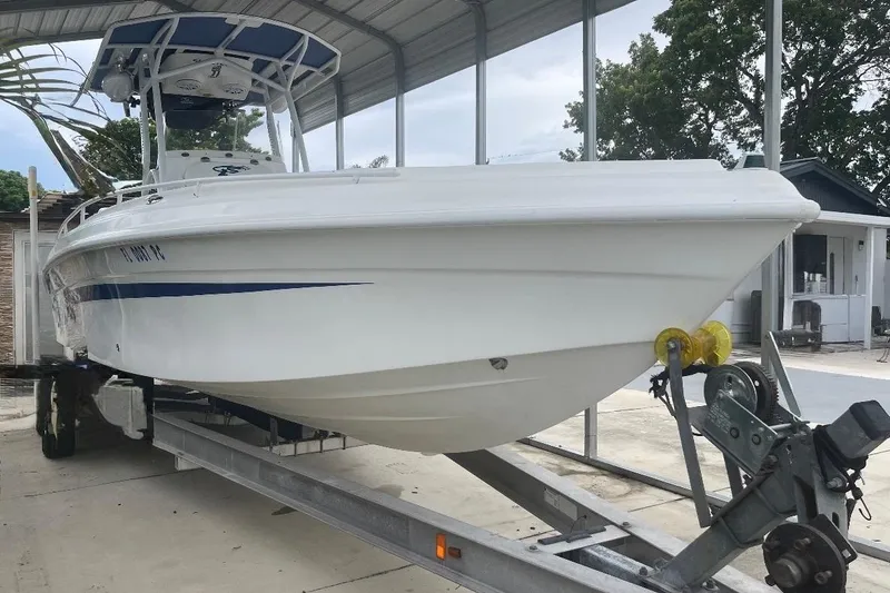 Slide: The Image of 2010 Glasstream 280 SCX boat on trailer under a metal canopy. - 4