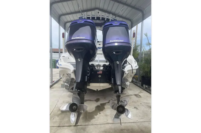 Slide: The Image of 2010 Glasstream 280 SCX boat with dual Saltwater outboard motors in a covered dock. - 6