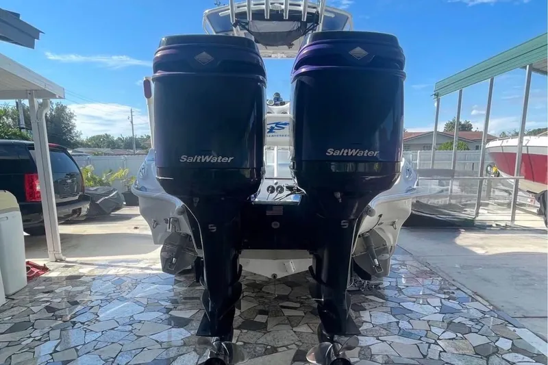 Slide: The Image of 2010 Glasstream 280 SCX boat with dual SaltWater outboard engines in a sunny driveway. - 7