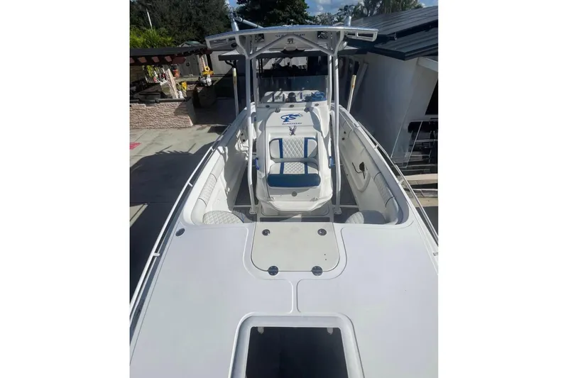 Slide: The Image of 2010 Glasstream 280 SCX boat with white and blue seating, docked outdoors. - 9