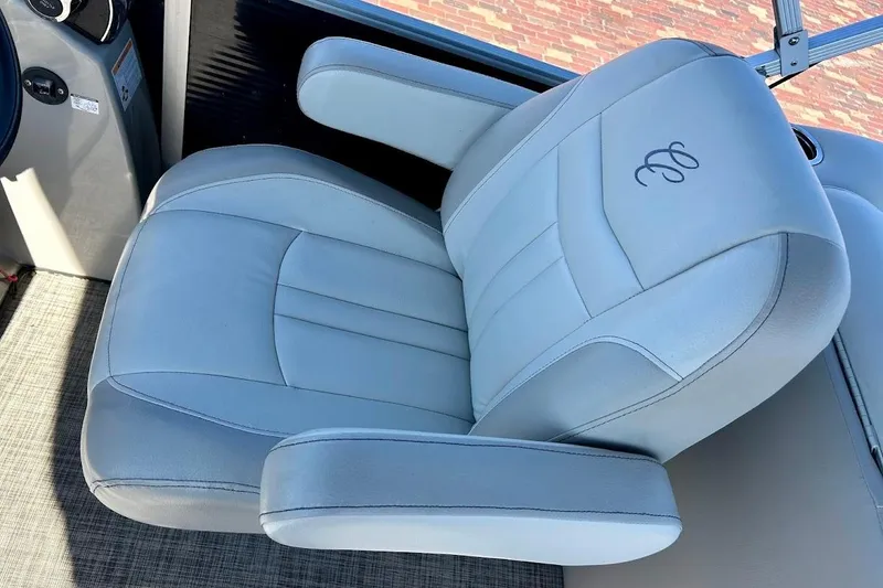 Slide: The Image of 2023 Cypress Cay Seabreeze 232 boat seat with embroidered logo, featuring plush gray upholstery. - 11