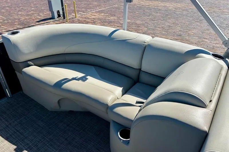 Slide: The Image of Luxurious seating on 2023 Cypress Cay Seabreeze 232 pontoon boat, featuring plush gray upholstery. - 14