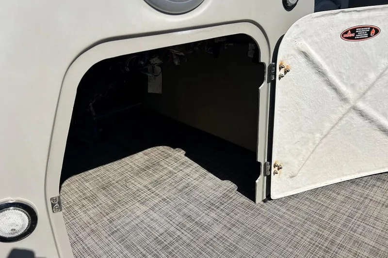 Slide: The Image of Open storage compartment on 2023 Cypress Cay Seabreeze 232 boat, featuring textured flooring. - 18