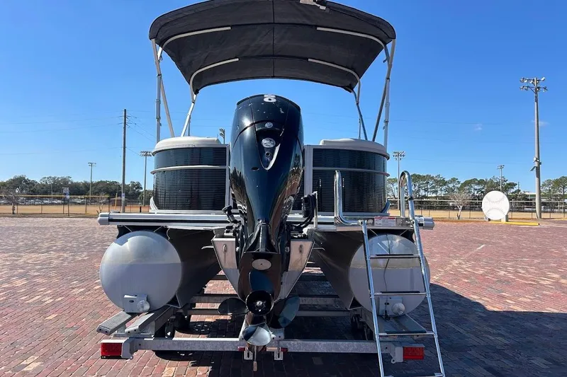 Slide: The Image of 2023 Cypress Cay Seabreeze 232 pontoon boat with outboard motor and canopy on trailer. - 3