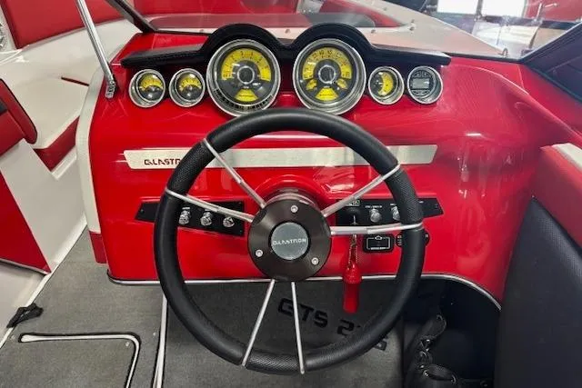 Slide: The Image of 2014 Glastron GTS 225 boat dashboard with red accents and multiple gauges. - 5